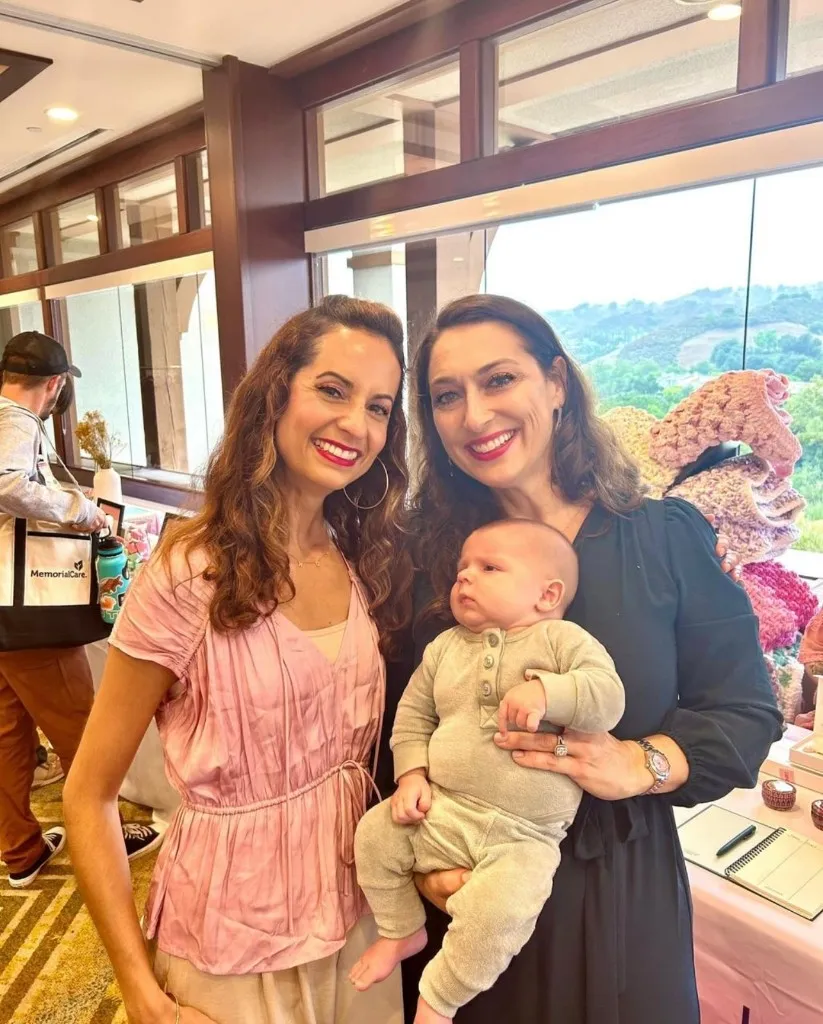 Tina Ghahramani-Singh, L.Ac. with a patient at a wellness event
